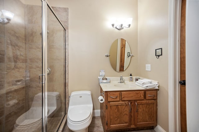 full bathroom featuring baseboards, toilet, vanity, and a stall shower