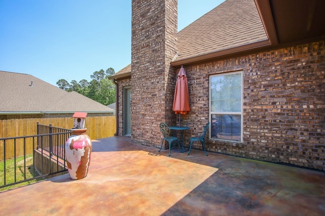 view of patio / terrace featuring fence