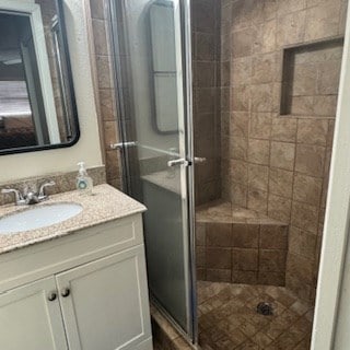 bathroom with an enclosed shower and vanity