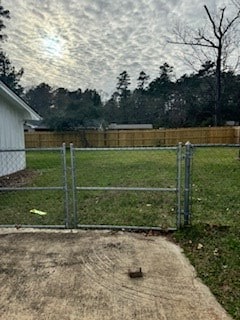 view of gate featuring a yard