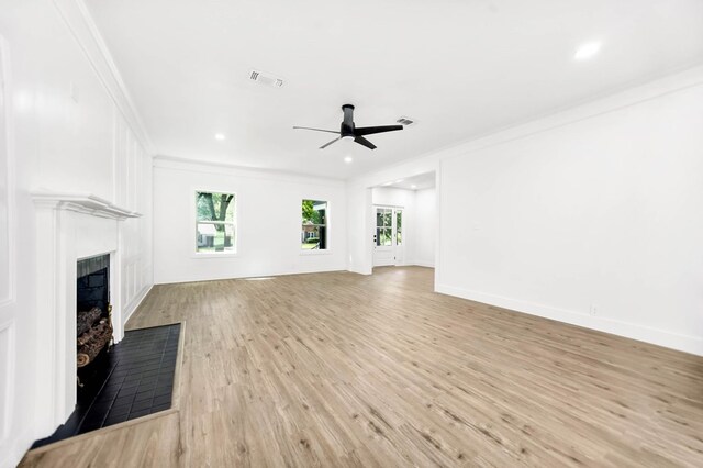 508 Jefferson Ave, Lufkin, TX 74904 - unfurnished living room with a ceiling fan, plenty of natural light, a fireplace, light wood finished floors, and crown molding