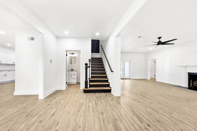 508 Jefferson Ave, Lufkin, TX 74904 - unfurnished living room with stairway, recessed lighting, light wood-style floors, a fireplace with flush hearth, and ceiling fan