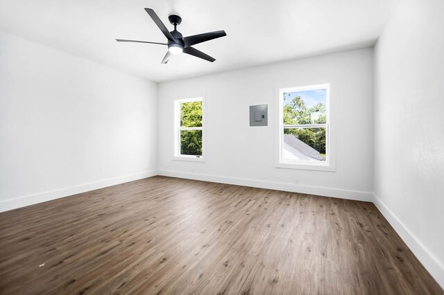 508 Jefferson Ave, Lufkin, TX 74904 - unfurnished room featuring healthy amount of natural light, electric panel, wood finished floors, and baseboards