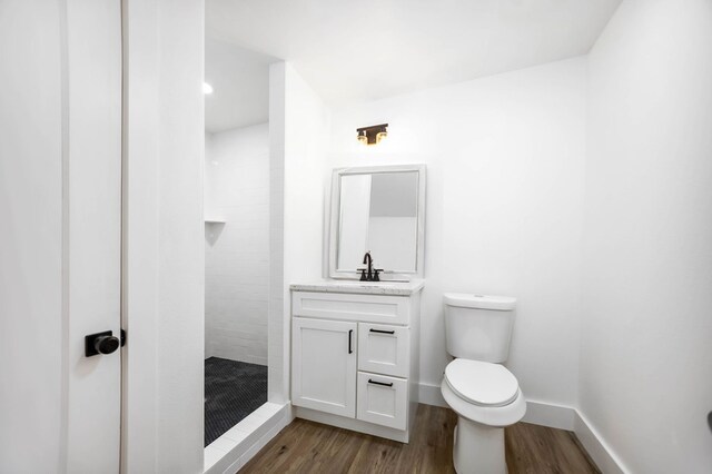 508 Jefferson Ave, Lufkin, TX 74904 - bathroom with a shower stall, toilet, wood finished floors, and vanity