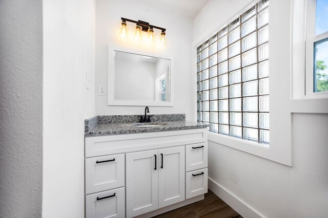 508 Jefferson Ave, Lufkin, TX 74904 - bathroom featuring vanity, wood finished floors, and baseboards