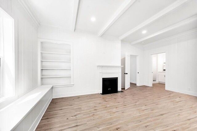 508 Jefferson Ave, Lufkin, TX 74904 - unfurnished living room with beamed ceiling, wood finished floors, a fireplace with flush hearth, crown molding, and baseboards