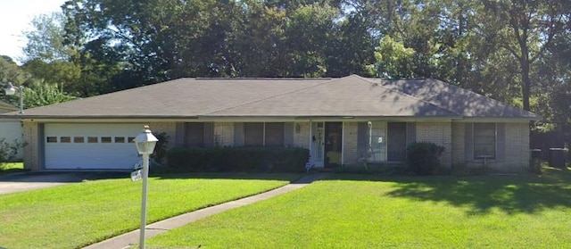 ranch-style house featuring a garage and a front yard