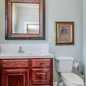 208 E Livingston St, San Augustine, TX 75972 - bathroom with vanity and toilet