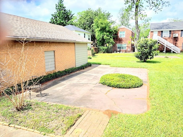208 E Livingston St, San Augustine, TX 75972 - view of green lawn with a patio area