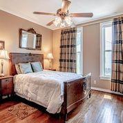208 E Livingston St, San Augustine, TX 75972 - bedroom featuring wood finished floors, ornamental molding, baseboards, and a ceiling fan
