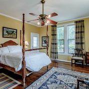 208 E Livingston St, San Augustine, TX 75972 - bedroom featuring multiple windows, ornamental molding, and wood finished floors