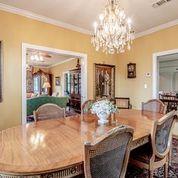 208 E Livingston St, San Augustine, TX 75972 - dining room with crown molding and a chandelier