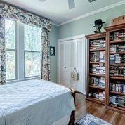 208 E Livingston St, San Augustine, TX 75972 - bedroom with crown molding, wood finished floors, and ceiling fan