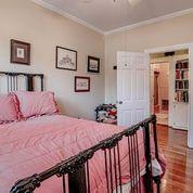 208 E Livingston St, San Augustine, TX 75972 - bedroom with ornamental molding, wood finished floors, and ceiling fan