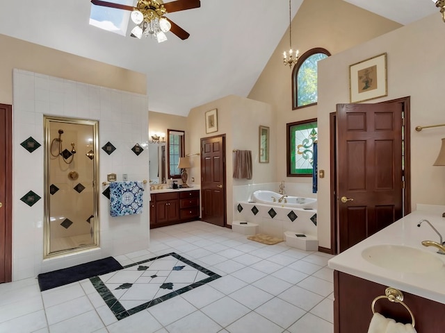 476 Jefferson Ave, Lufkin, TX 75904 - full bathroom featuring ceiling fan, tile patterned flooring, a shower stall, a garden tub, and vanity