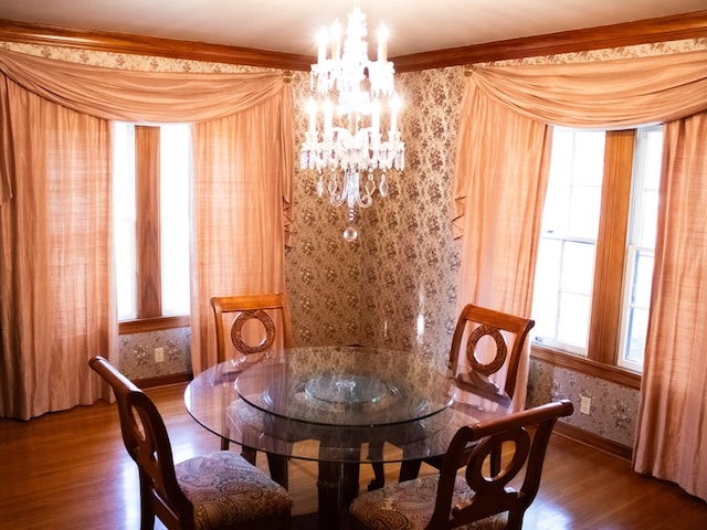 476 Jefferson Ave, Lufkin, TX 75904 - dining area featuring a chandelier, plenty of natural light, wood finished floors, baseboards, and wallpapered walls