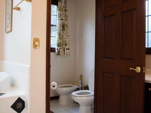 476 Jefferson Ave, Lufkin, TX 75904 - bathroom with a bidet, toilet, tile patterned floors, and healthy amount of natural light