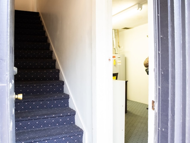 476 Jefferson Ave, Lufkin, TX 75904 - staircase featuring water heater and carpet