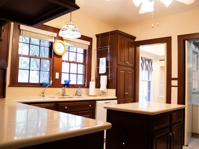 476 Jefferson Ave, Lufkin, TX 75904 - kitchen with a sink, light countertops, white dishwasher, and a ceiling fan