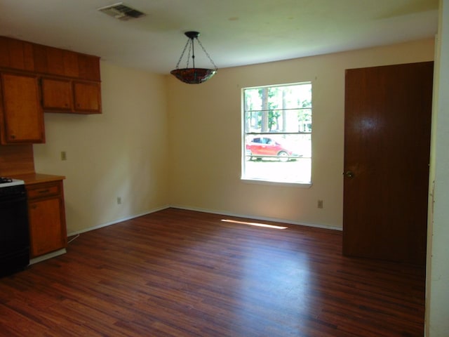 1202 Mimosa, Lufkin, TX 75901 - kitchen featuring electric range oven, dark wood-type flooring, brown cabinets, and light countertops