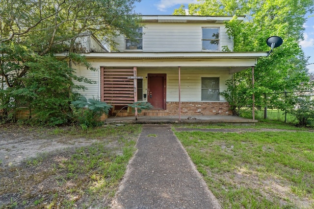 1316 N Raguet, Lufkin, TX 75904 - view of front facade featuring covered porch and brick siding