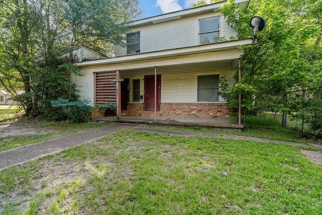 1316 N Raguet, Lufkin, TX 75904 - view of front facade with covered porch, brick siding, and a front yard