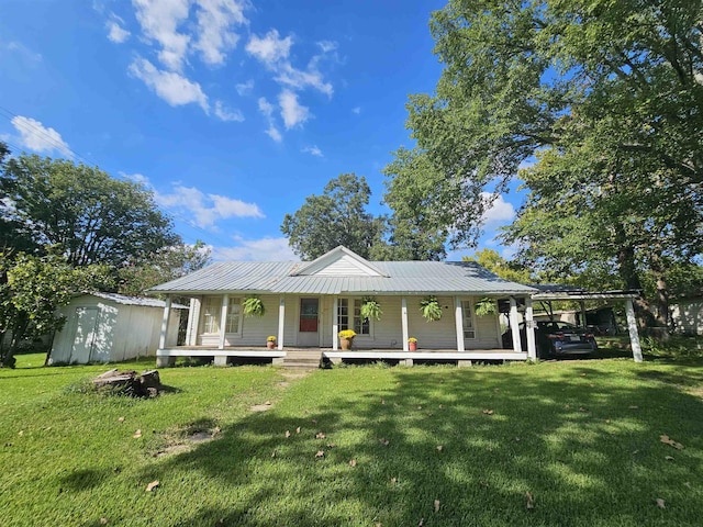 farmhouse featuring a carport, a porch, and a front yard