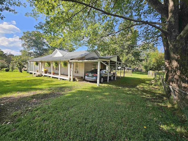 exterior space with covered porch, an attached carport, and fence