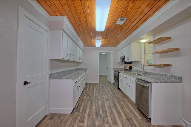 kitchen with visible vents, white cabinets, appliances with stainless steel finishes, open shelves, and a sink