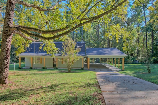 view of front facade with a carport, concrete driveway, covered porch, and a front lawn