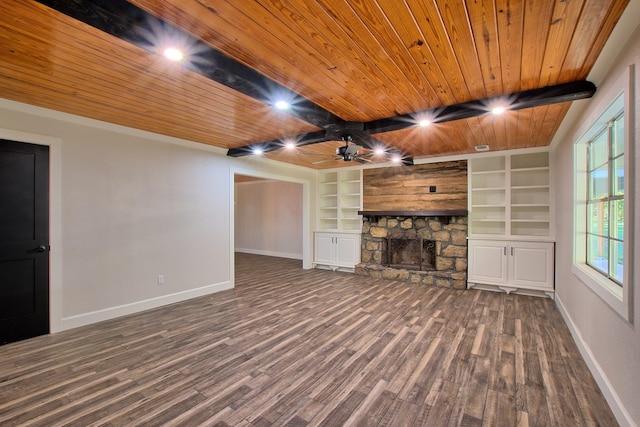 unfurnished living room with wood ceiling, a fireplace, baseboards, and wood finished floors