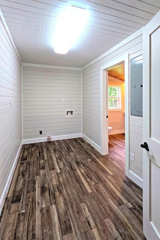 613 S Kennon St, Hemphill, TX 75948 - unfurnished room with electric panel, dark wood finished floors, baseboards, and wood walls