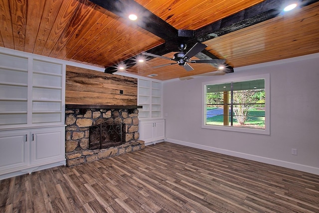 unfurnished living room with wooden ceiling, built in shelves, baseboards, and a fireplace