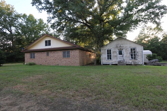 view of home's exterior featuring a yard