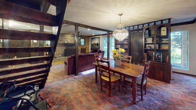 carpeted dining space featuring a textured ceiling, an inviting chandelier, and a brick fireplace