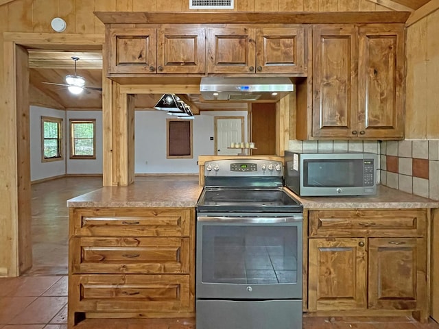 kitchen featuring light countertops, stainless steel appliances, visible vents, and extractor fan