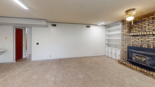 unfurnished living room with carpet flooring and a textured ceiling