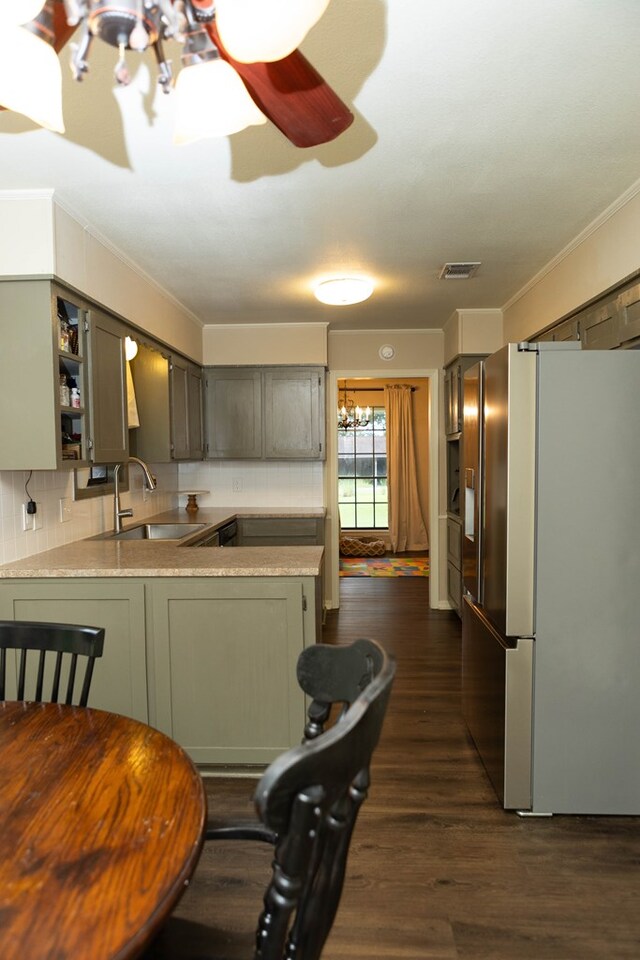 157 Craig St, Jasper, TX 75951 - kitchen with stainless steel fridge with ice dispenser, a chandelier, ornamental molding, a peninsula, and dark wood-type flooring