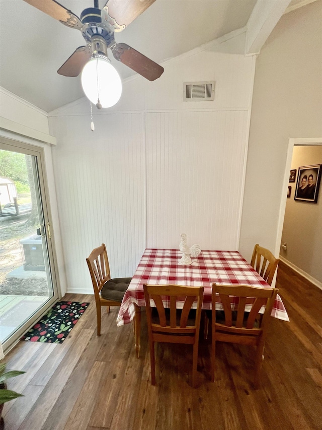 dining room with hardwood / wood-style flooring, ceiling fan, and lofted ceiling