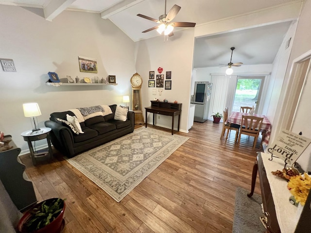 living room with vaulted ceiling with beams, ceiling fan, and wood-type flooring