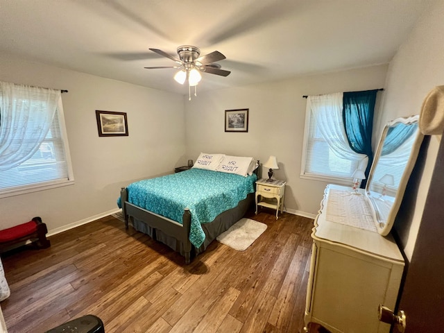 bedroom with ceiling fan and dark hardwood / wood-style flooring