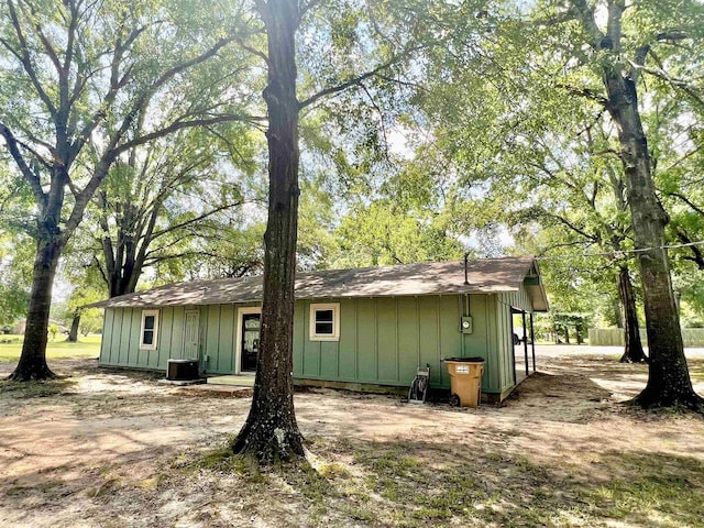 back of house with central air condition unit