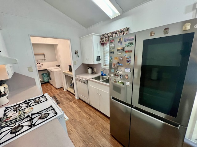 kitchen with light wood-type flooring, white appliances, sink, white cabinetry, and lofted ceiling