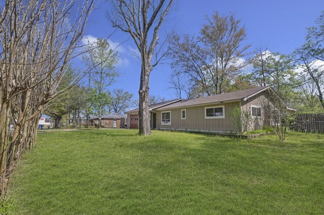 exterior space with a lawn and fence