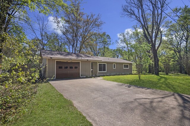 ranch-style house with a garage, a front lawn, and concrete driveway