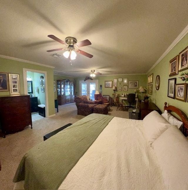 bedroom with french doors, ensuite bath, ceiling fan, ornamental molding, and light colored carpet