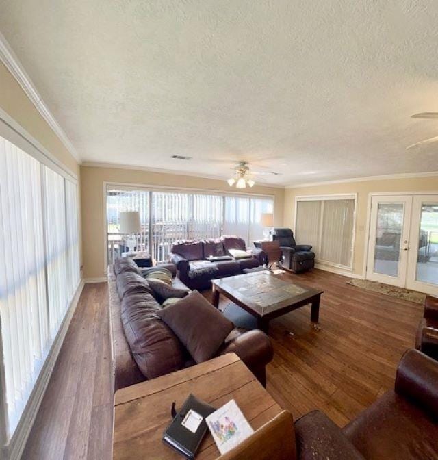 living room featuring plenty of natural light, wood-type flooring, and a textured ceiling