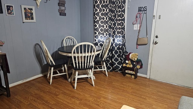 dining space with wood-type flooring