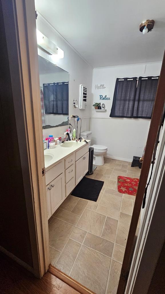 bathroom featuring toilet and vanity