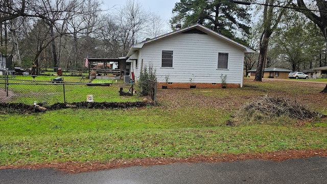 view of side of property with a yard